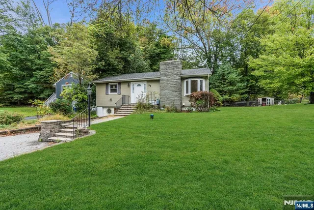 a view of a house with a yard and sitting area