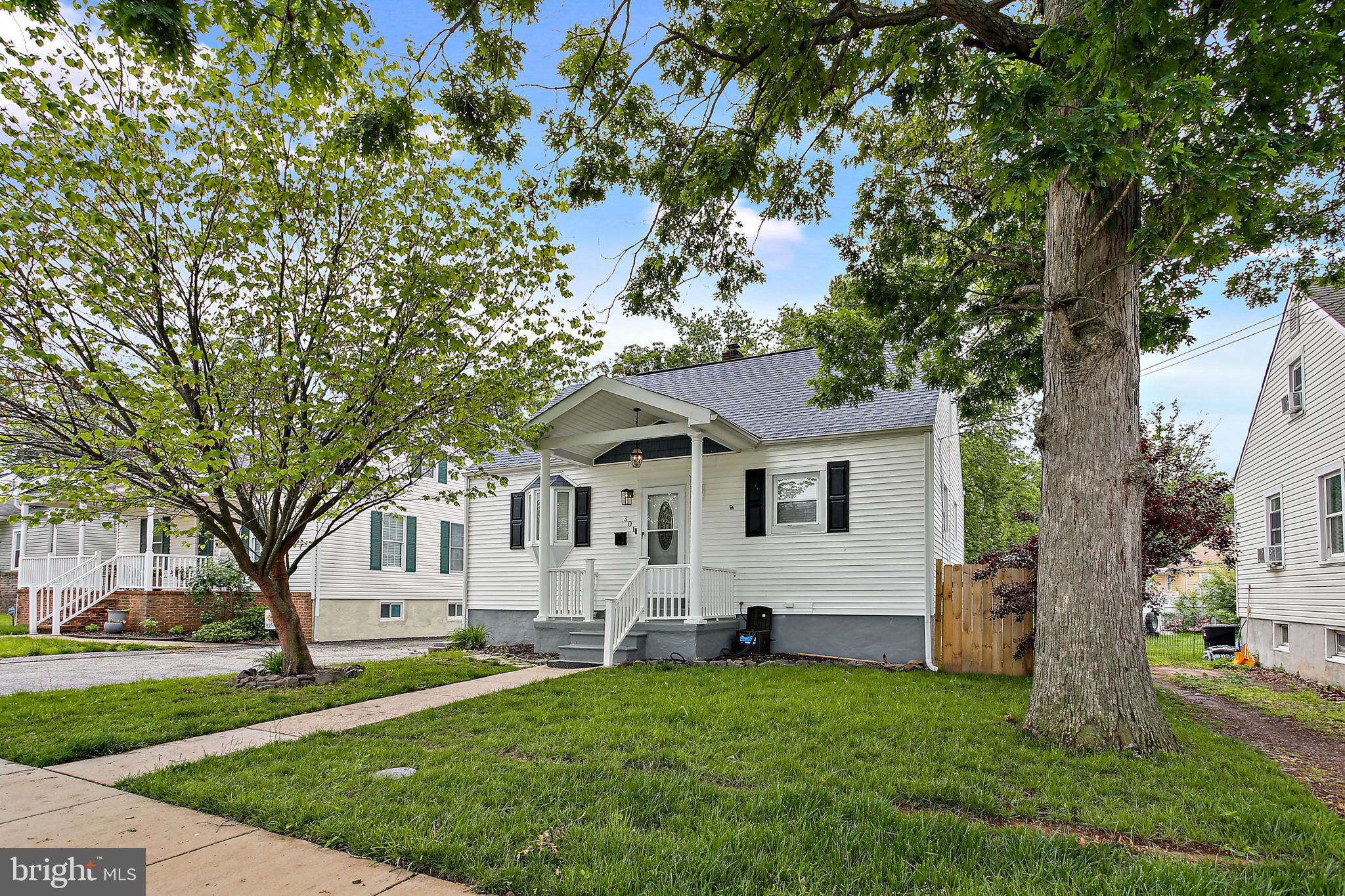 301 Townsend Road Essex, MD 21221 - Photo 1 of 33 a white house that has a tree in front of it