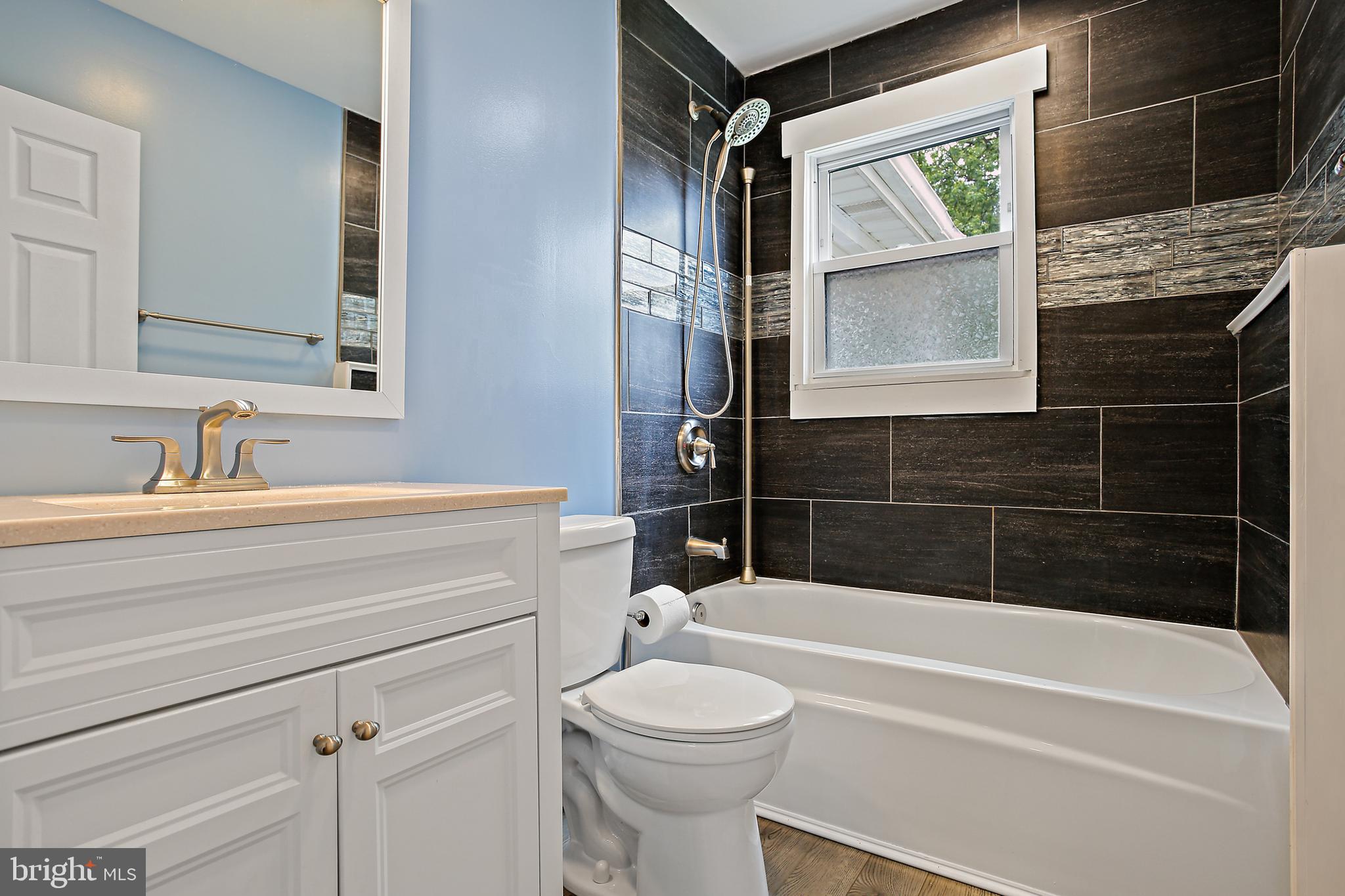 301 Townsend Road Essex, MD 21221 - Photo 12 of 33 a bathroom with a sink a toilet and shower