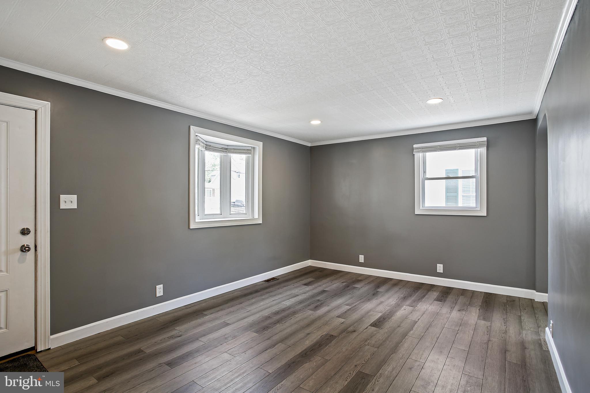 301 Townsend Road Essex, MD 21221 - Photo 13 of 33 a view of a big room with wooden floor and windows