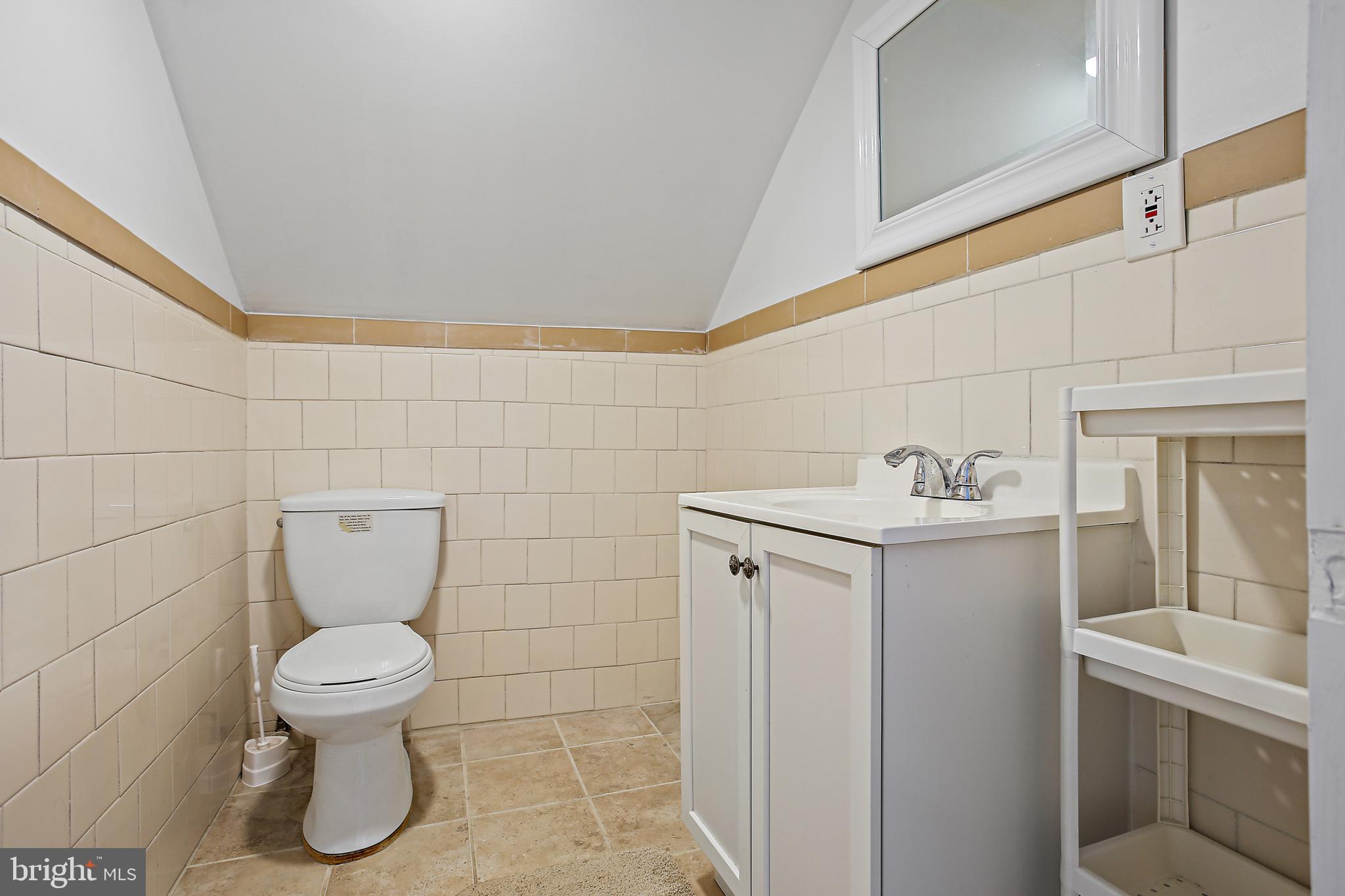 301 Townsend Road Essex, MD 21221 - Photo 20 of 33 a bathroom with a toilet sink and mirror