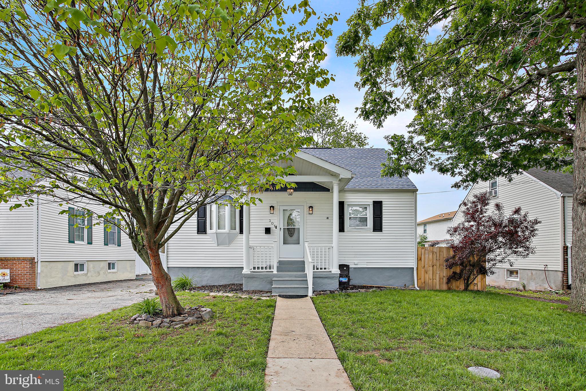 301 Townsend Road Essex, MD 21221 - Photo 2 of 33 a front view of a house with a yard and garage