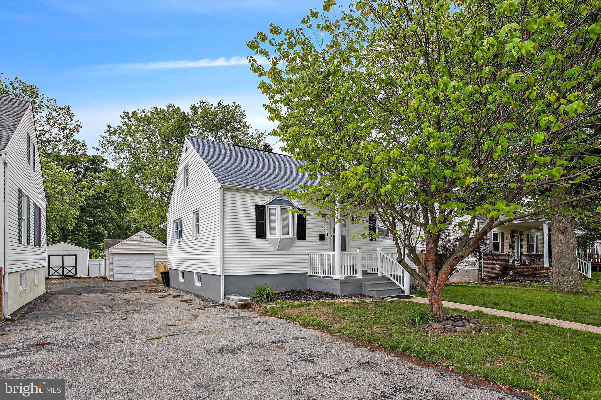 301 Townsend Road Essex, MD 21221 - Photo 3 of 33 a view of a yard in front of a house with plants and large tree