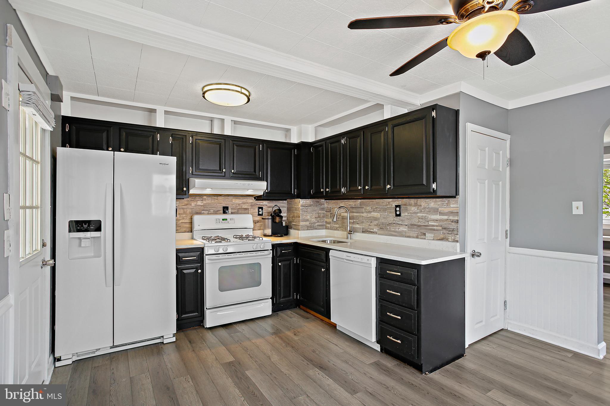 301 Townsend Road Essex, MD 21221 - Photo 6 of 33 a kitchen with a sink a stove and refrigerator
