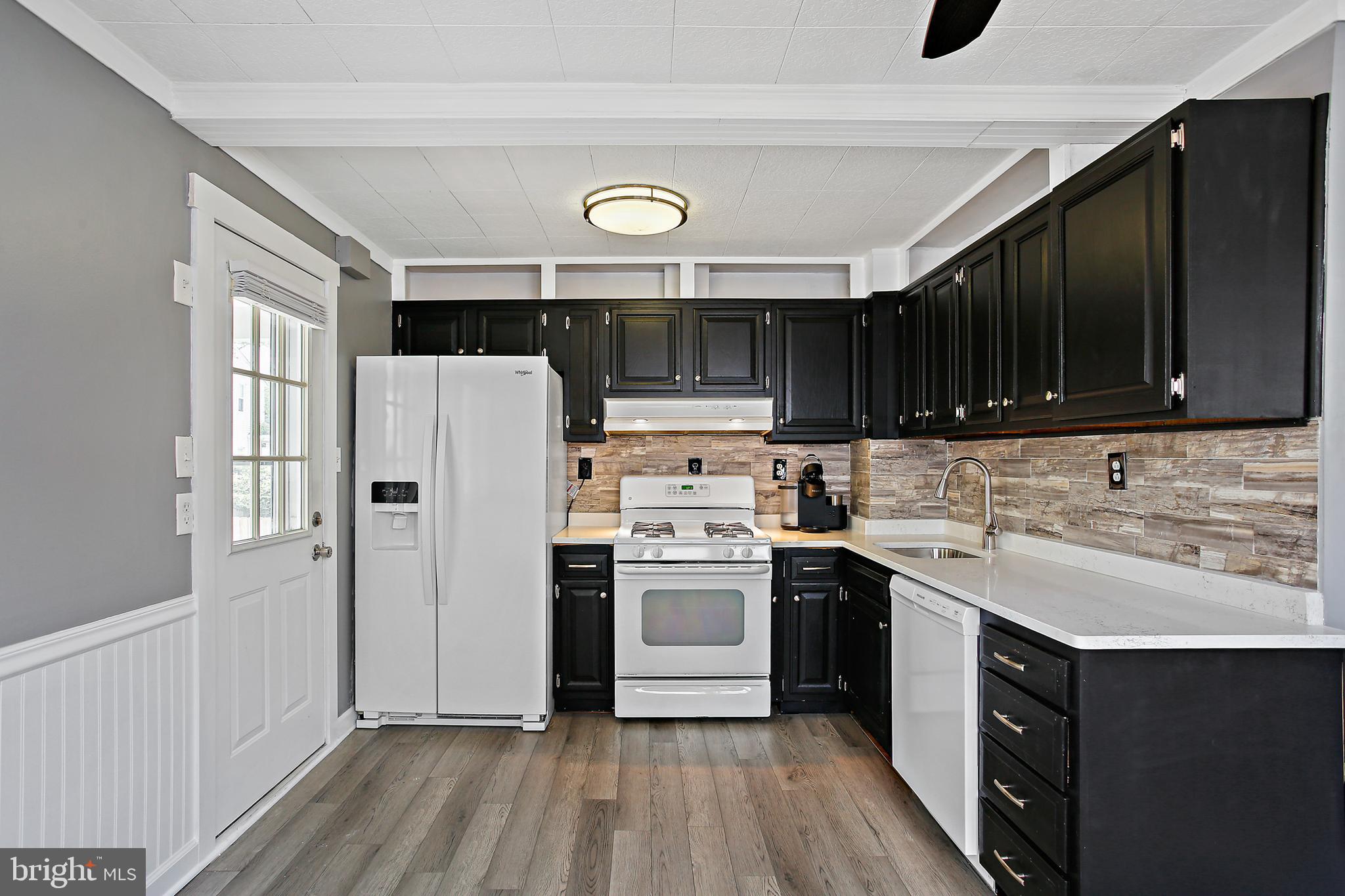 301 Townsend Road Essex, MD 21221 - Photo 7 of 33 a kitchen with a stove a sink and a microwave