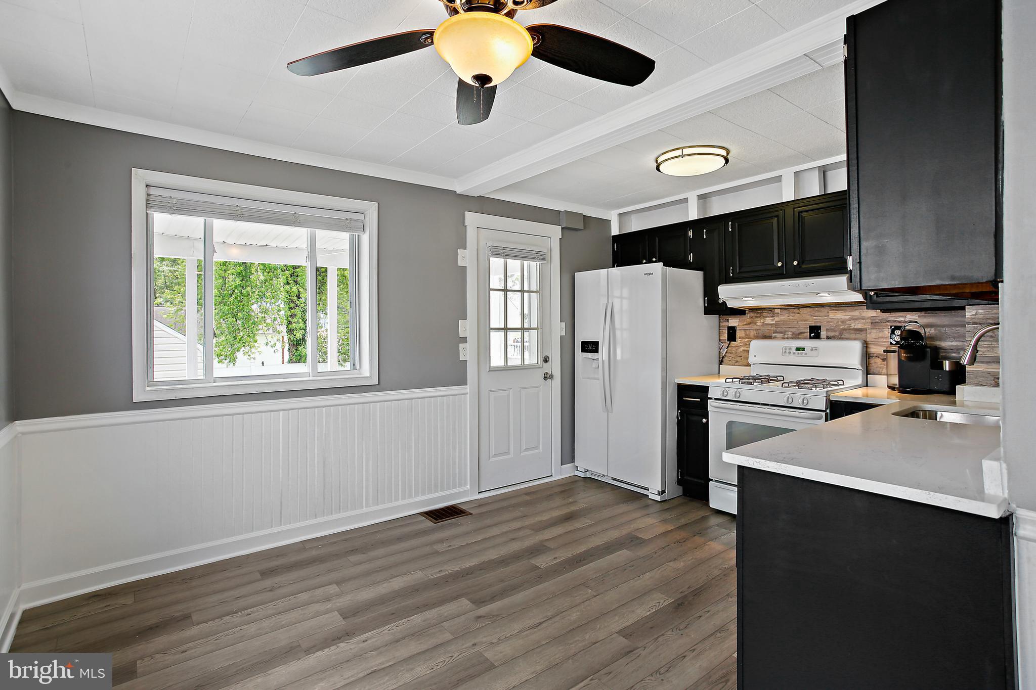 301 Townsend Road Essex, MD 21221 - Photo 8 of 33 a kitchen with stainless steel appliances a refrigerator and a stove top oven