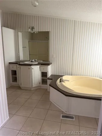 a bathroom with a bathtub and a sink