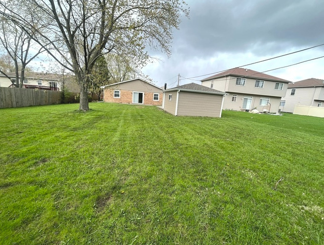 547 Regent Road University Park, IL 60484 - Photo 14 of 14 a view of a big house with a big yard and large tree