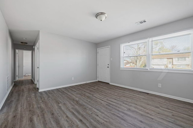 547 Regent Road University Park, IL 60484 - Photo 2 of 14 a view of an empty room with wooden floor and a window