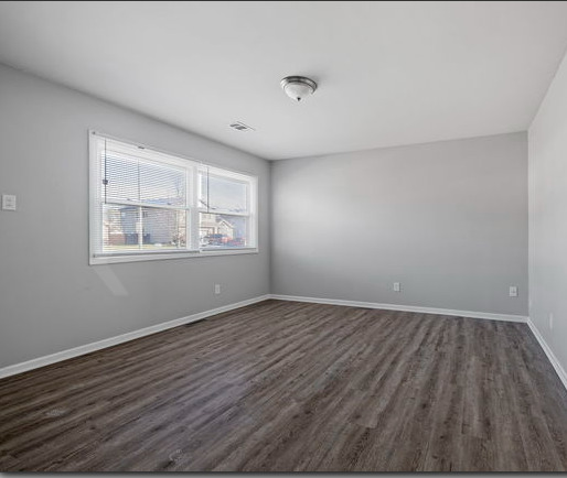 547 Regent Road University Park, IL 60484 - Photo 3 of 14 a view of an empty room with wooden floor and a window