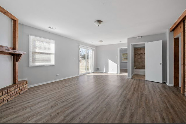 547 Regent Road University Park, IL 60484 - Photo 7 of 14 a view of an empty room with wooden floor and a window