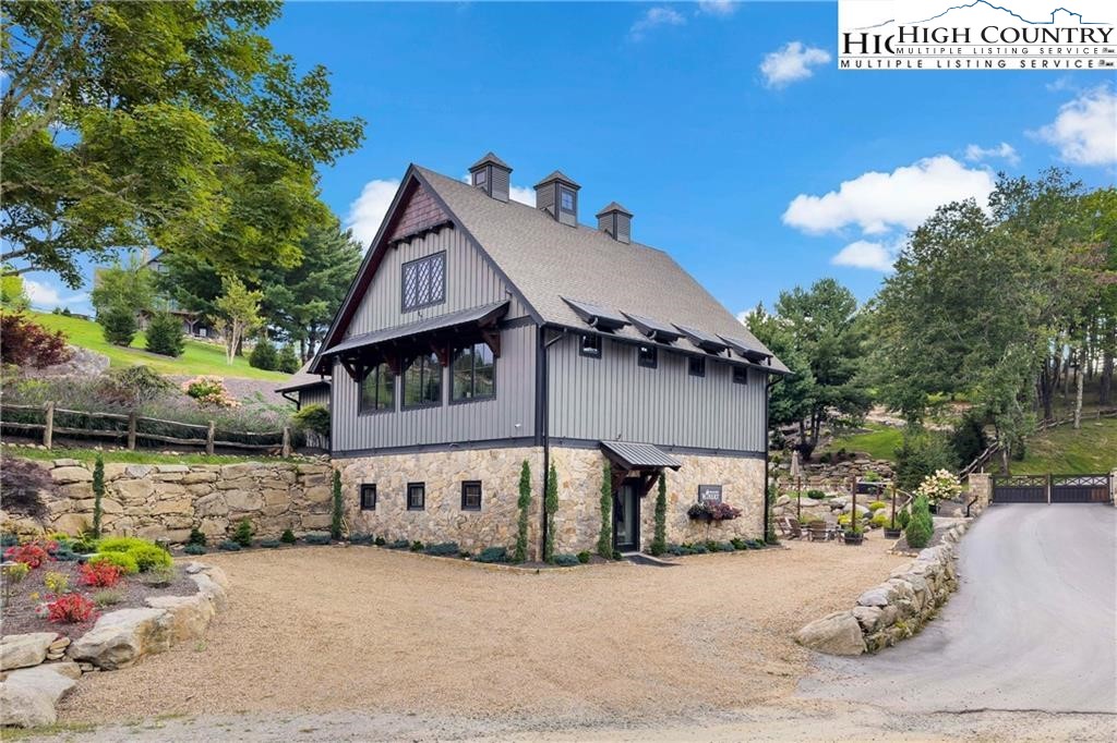 80 Lands End Trail Banner Elk, NC 28604 - Photo 30 of 31 a view of a house with a yard and a car parked beside of it