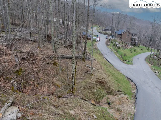 a view of a wooden house with a yard