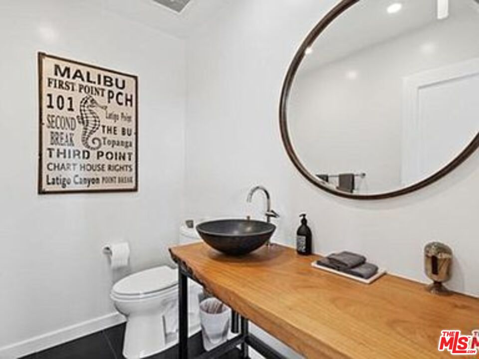 Roca Chica Drive Malibu, CA 90265 - Photo 13 of 34 a bathroom with a toilet a sink and a mirror