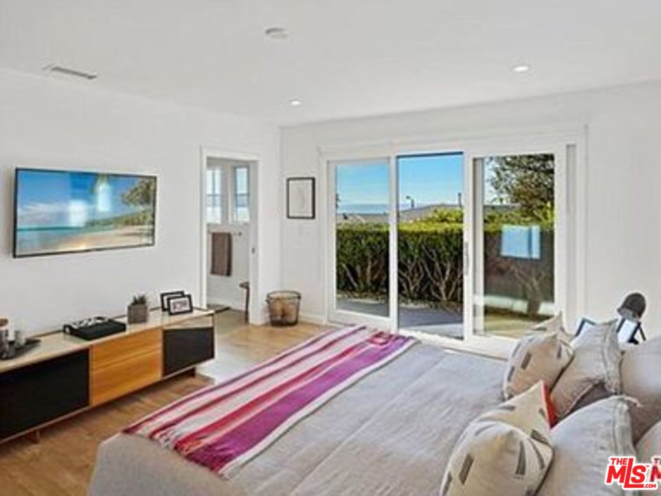 Roca Chica Drive Malibu, CA 90265 - Photo 14 of 34 a living room with furniture a flat screen tv and a floor to ceiling window