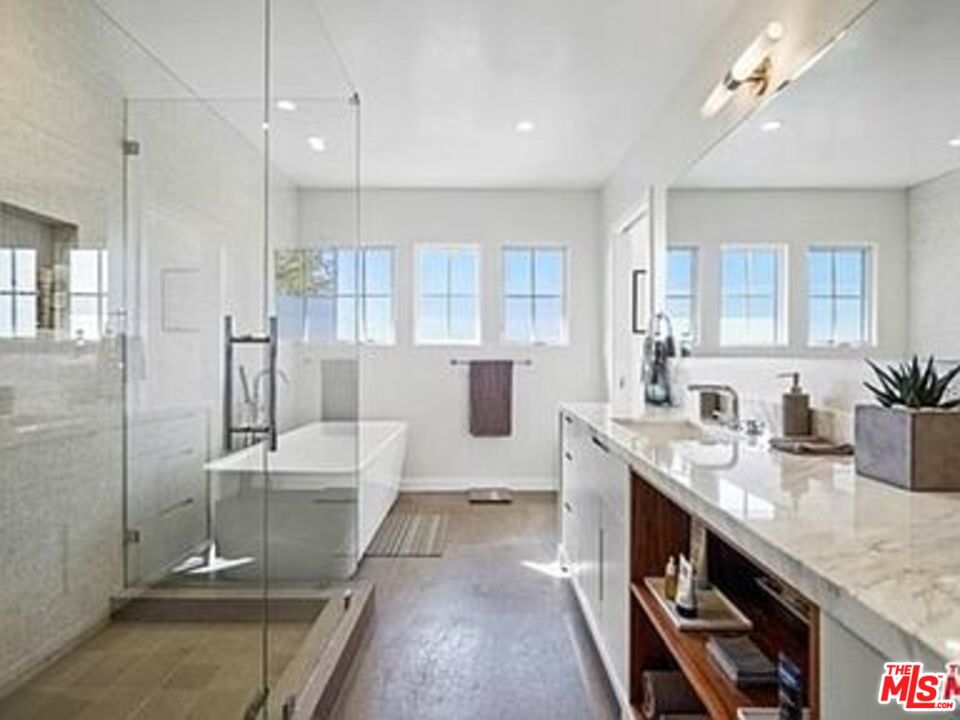 Roca Chica Drive Malibu, CA 90265 - Photo 16 of 34 a bathroom with a granite countertop sink a toilet a mirror and shower