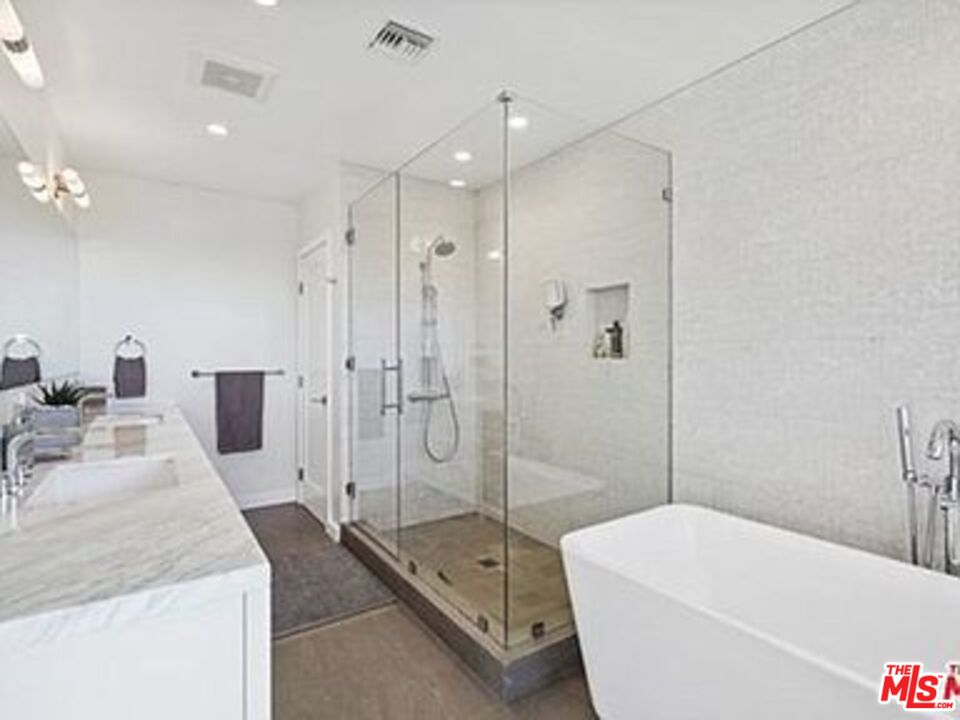 Roca Chica Drive Malibu, CA 90265 - Photo 17 of 34 a spacious bathroom with a tub shower a mirror and a sink
