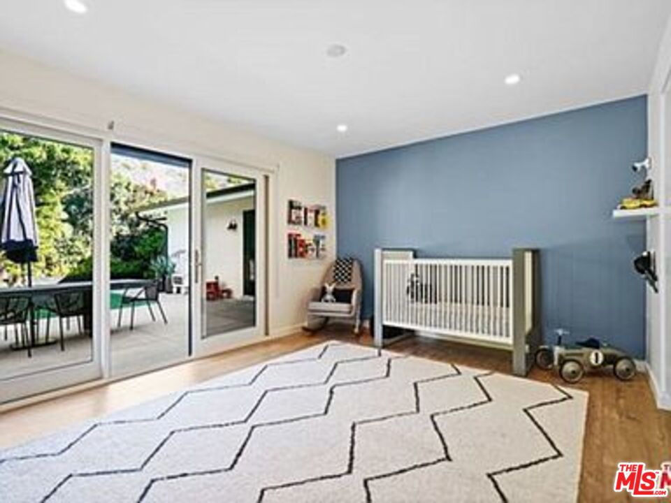 Roca Chica Drive Malibu, CA 90265 - Photo 18 of 34 a bedroom with furniture and large windows