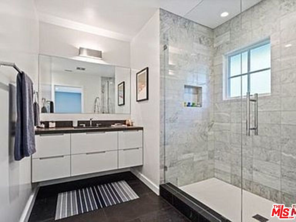Roca Chica Drive Malibu, CA 90265 - Photo 20 of 34 a bathroom with a sink a mirror and a shower