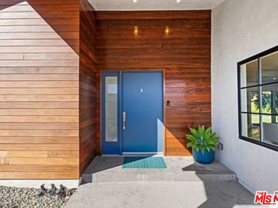 Roca Chica Drive Malibu, CA 90265 - Photo 2 of 34 a brick house with potted plants in front of door