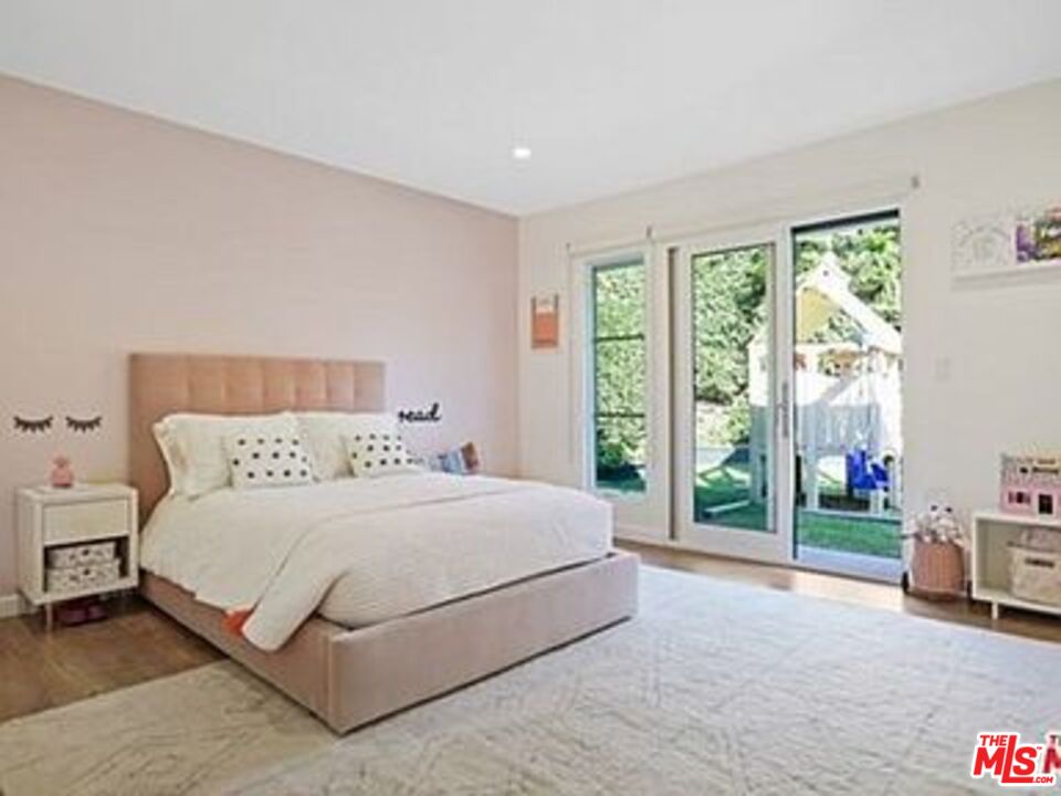 Roca Chica Drive Malibu, CA 90265 - Photo 21 of 34 a bedroom with a bed lamp and a large window