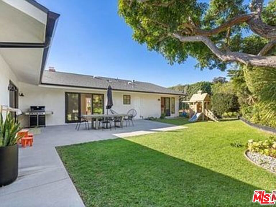 Roca Chica Drive Malibu, CA 90265 - Photo 24 of 34 a patio with table and chairs and potted plants