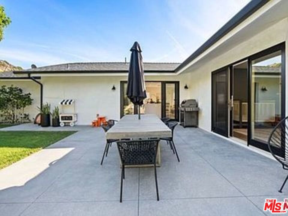 Roca Chica Drive Malibu, CA 90265 - Photo 26 of 34 a view of a patio with table and chairs