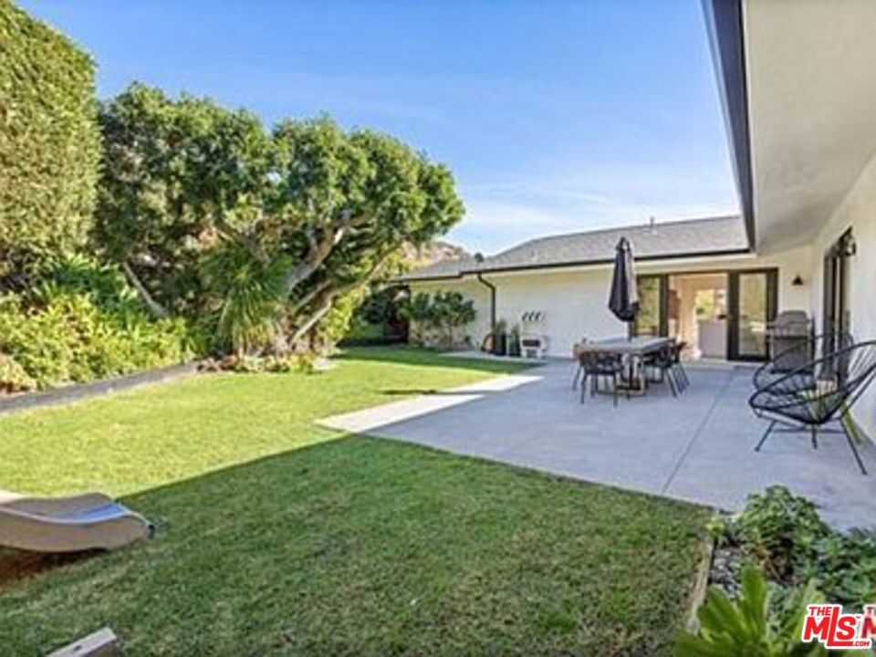 Roca Chica Drive Malibu, CA 90265 - Photo 27 of 34 a view of a house with backyard porch and sitting area