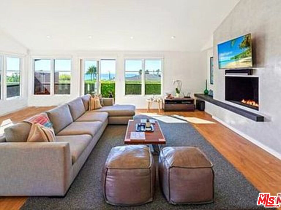 Roca Chica Drive Malibu, CA 90265 - Photo 4 of 34 a living room with furniture large window and a fireplace