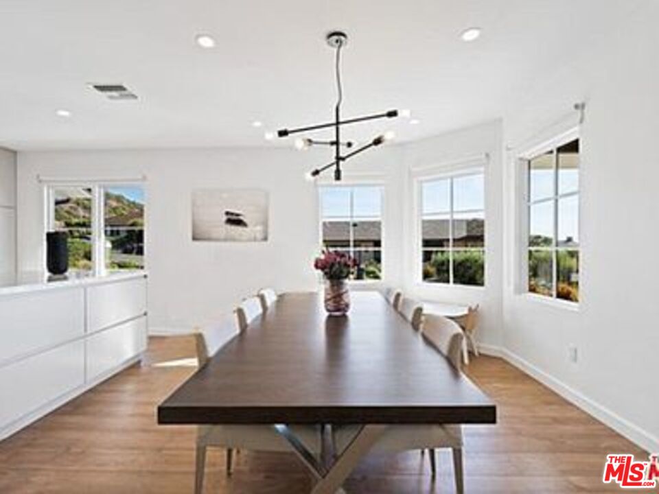 Roca Chica Drive Malibu, CA 90265 - Photo 8 of 34 a view of a dining room with furniture window and wooden floor