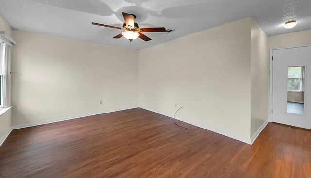 wooden floor in an empty room with a window