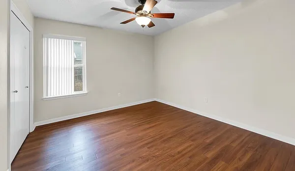 wooden floor in an empty room with a window