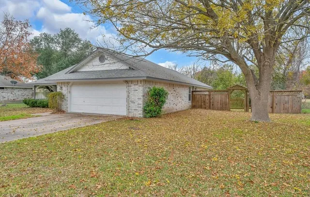 a front view of house with yard and trees