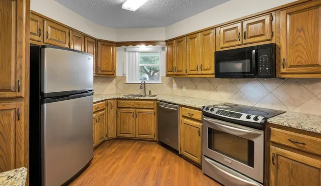 a kitchen with a refrigerator stove and microwave