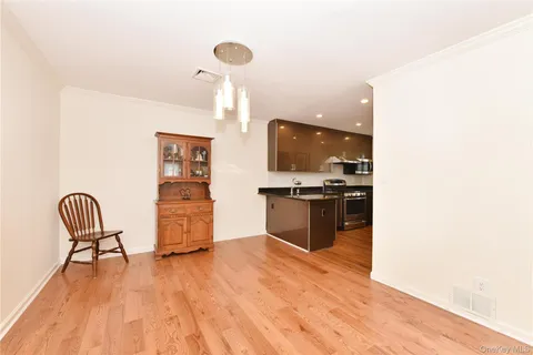 a kitchen with stainless steel appliances kitchen island granite countertop a sink and wooden floor