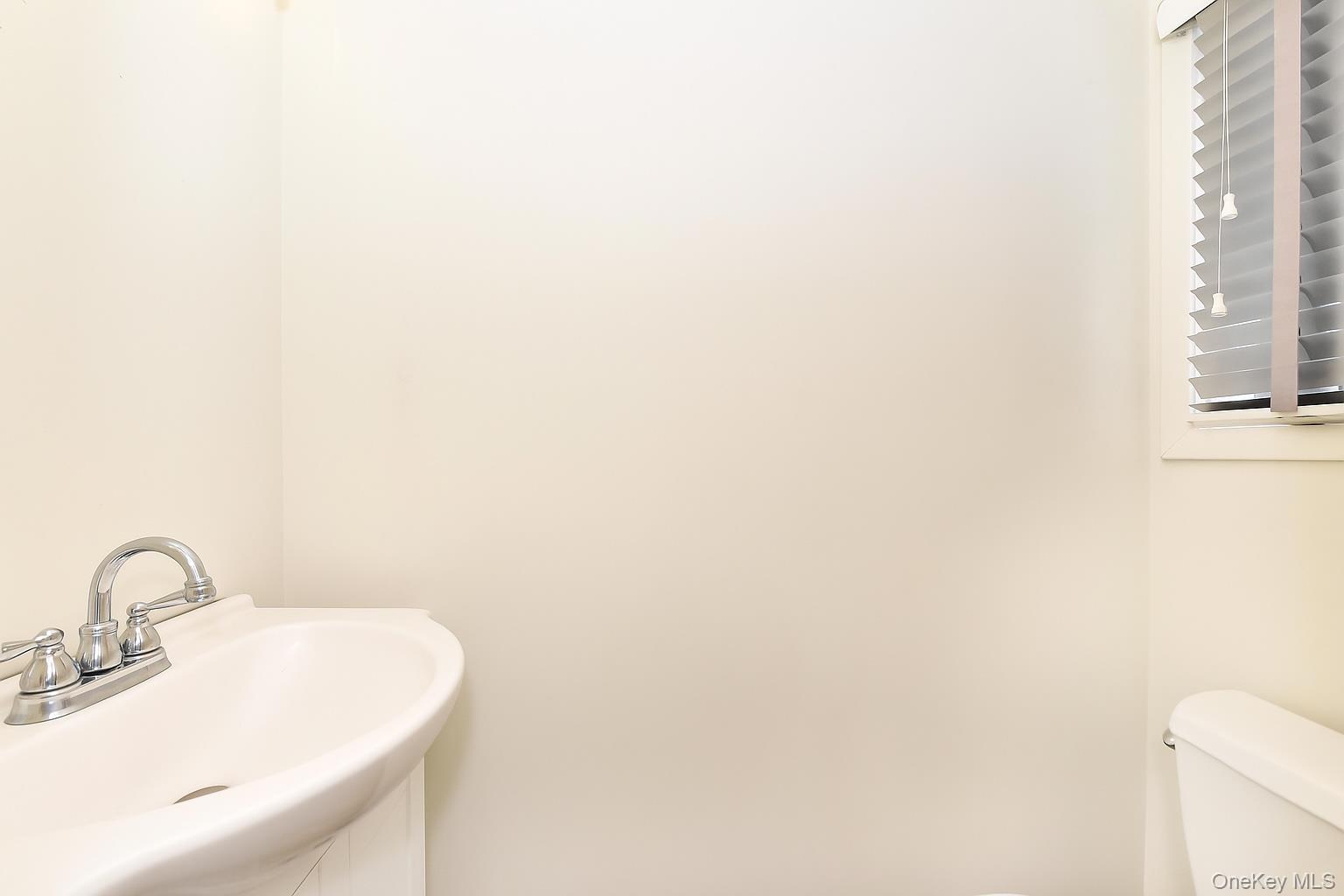 142 I U Willets Road Albertson, NY 11507 - Photo 17 of 32 a bathroom with a sink and a mirror