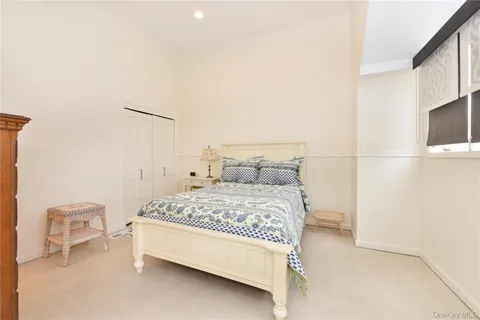 a bedroom with a bed and a television