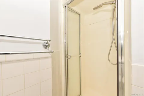 a bathroom with a glass shower door
