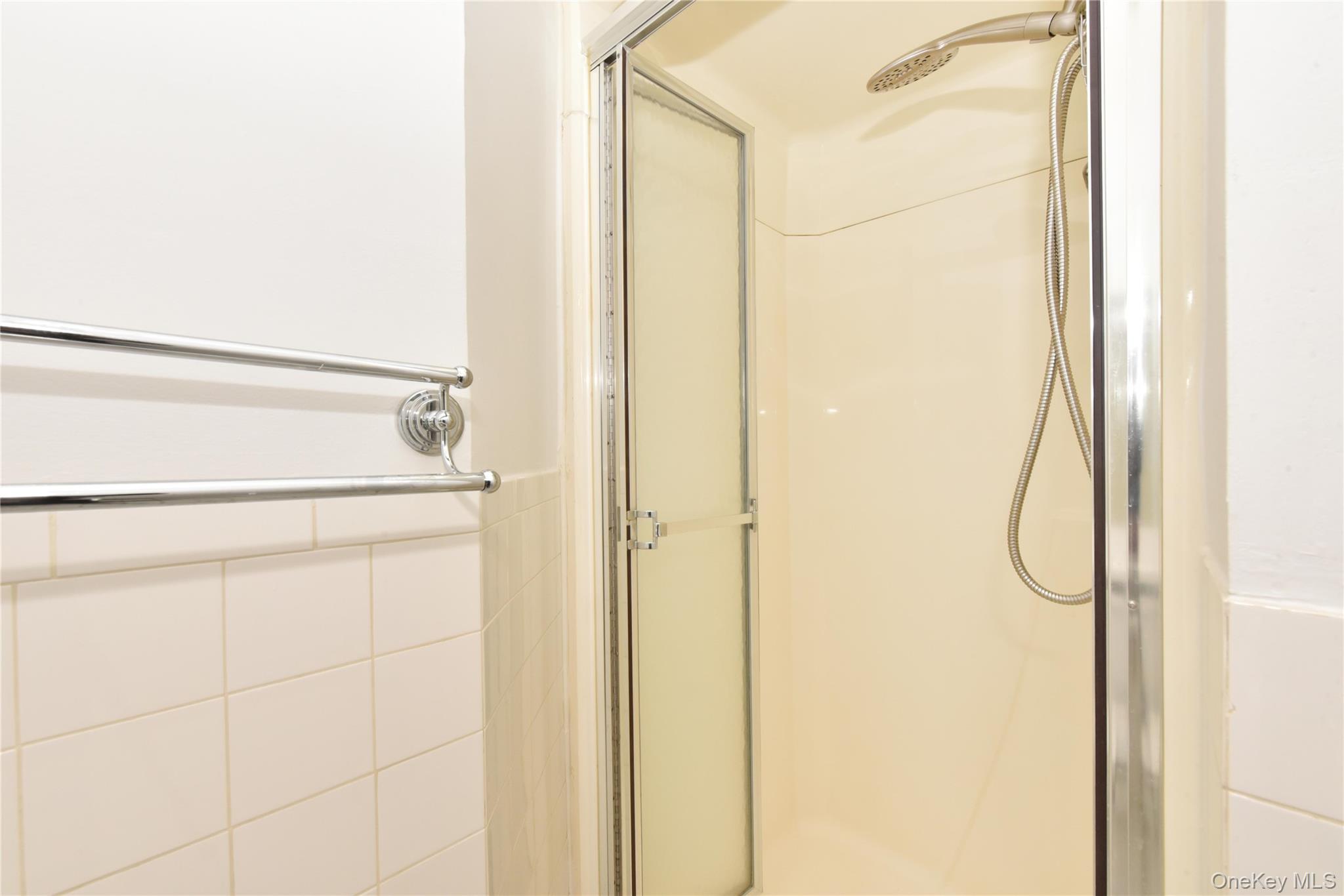 142 I U Willets Road Albertson, NY 11507 - Photo 27 of 32 a bathroom with a glass shower door