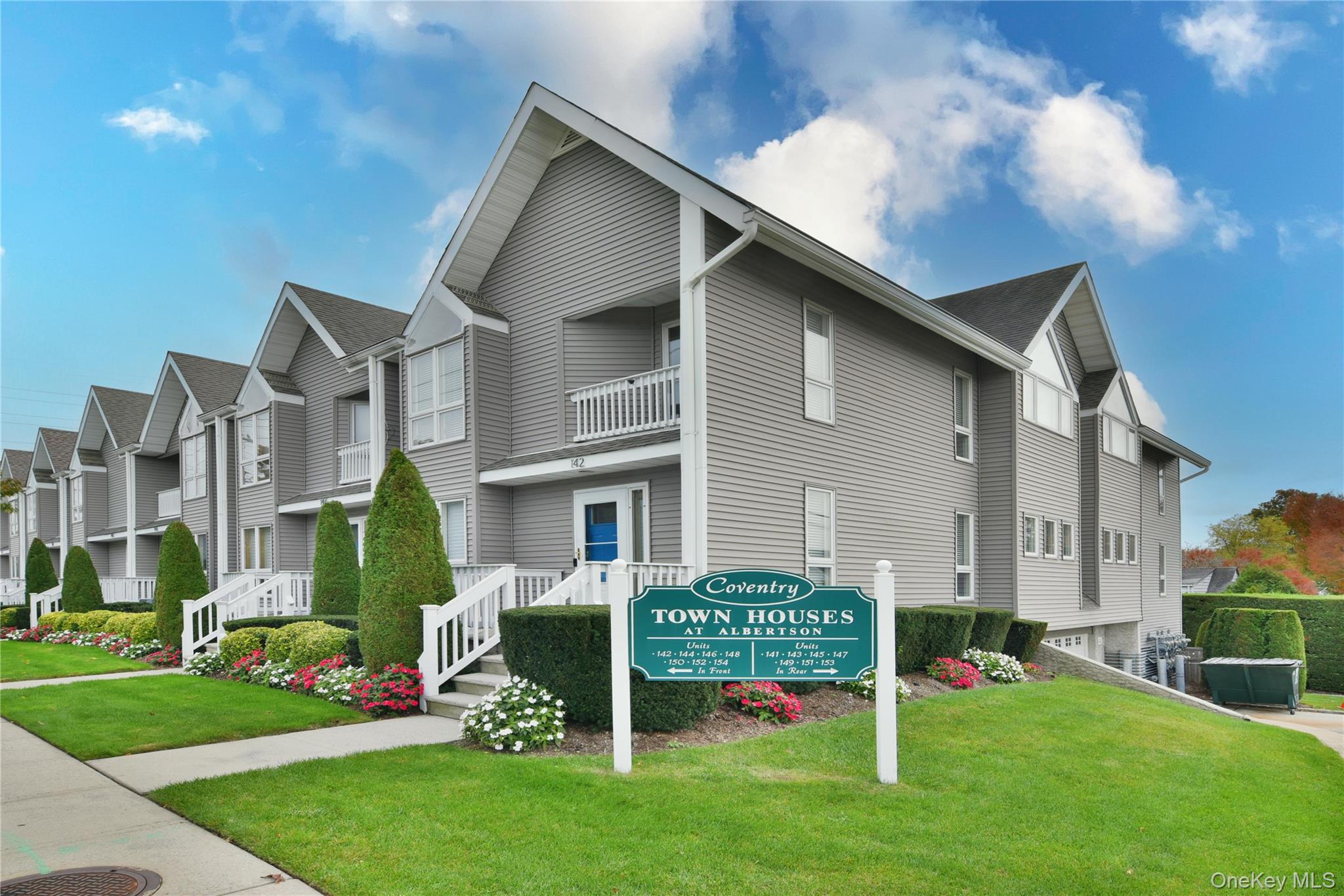 142 I U Willets Road Albertson, NY 11507 - Photo 3 of 32 a front view of a house with a yard table and chairs