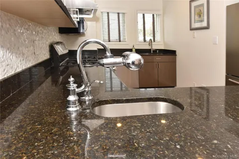 a bathroom with granite countertop a sink and a granite countertop