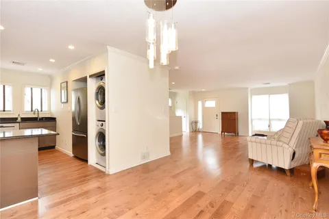 a living room with furniture and a kitchen