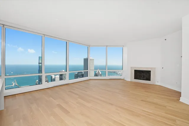 a view of an empty room with closet and a window