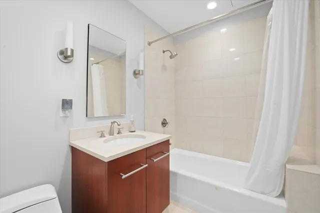 a bathroom with a sink mirror toilet and bathtub