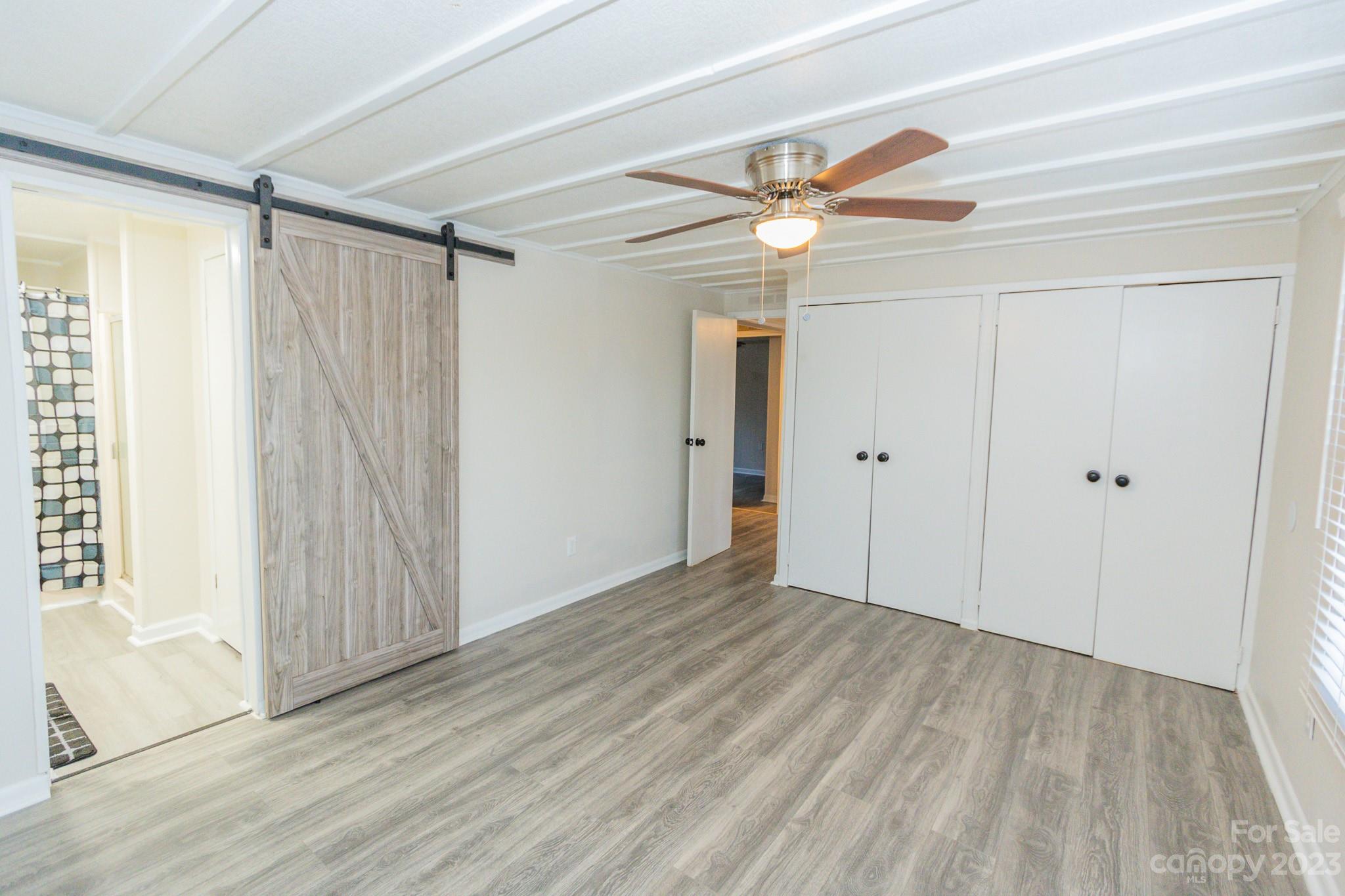 4634 Pleasant Road Heath Springs, SC 29058 - Photo 13 of 43 an empty room with wooden floor fan and windows