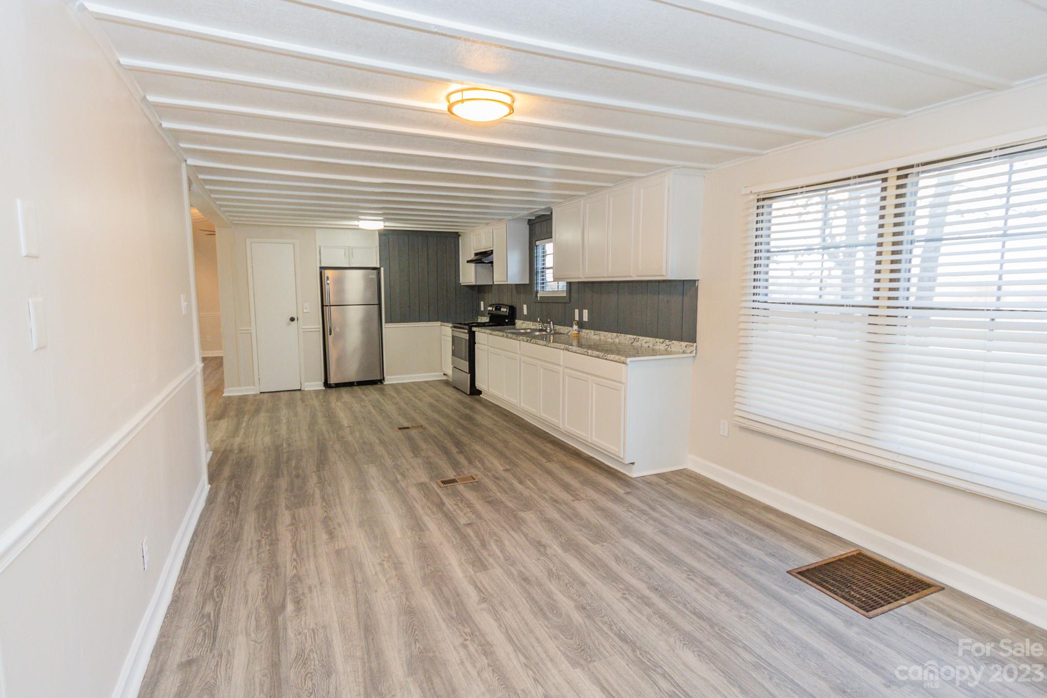 4634 Pleasant Road Heath Springs, SC 29058 - Photo 18 of 43 a view of a kitchen with a sink and wooden floor