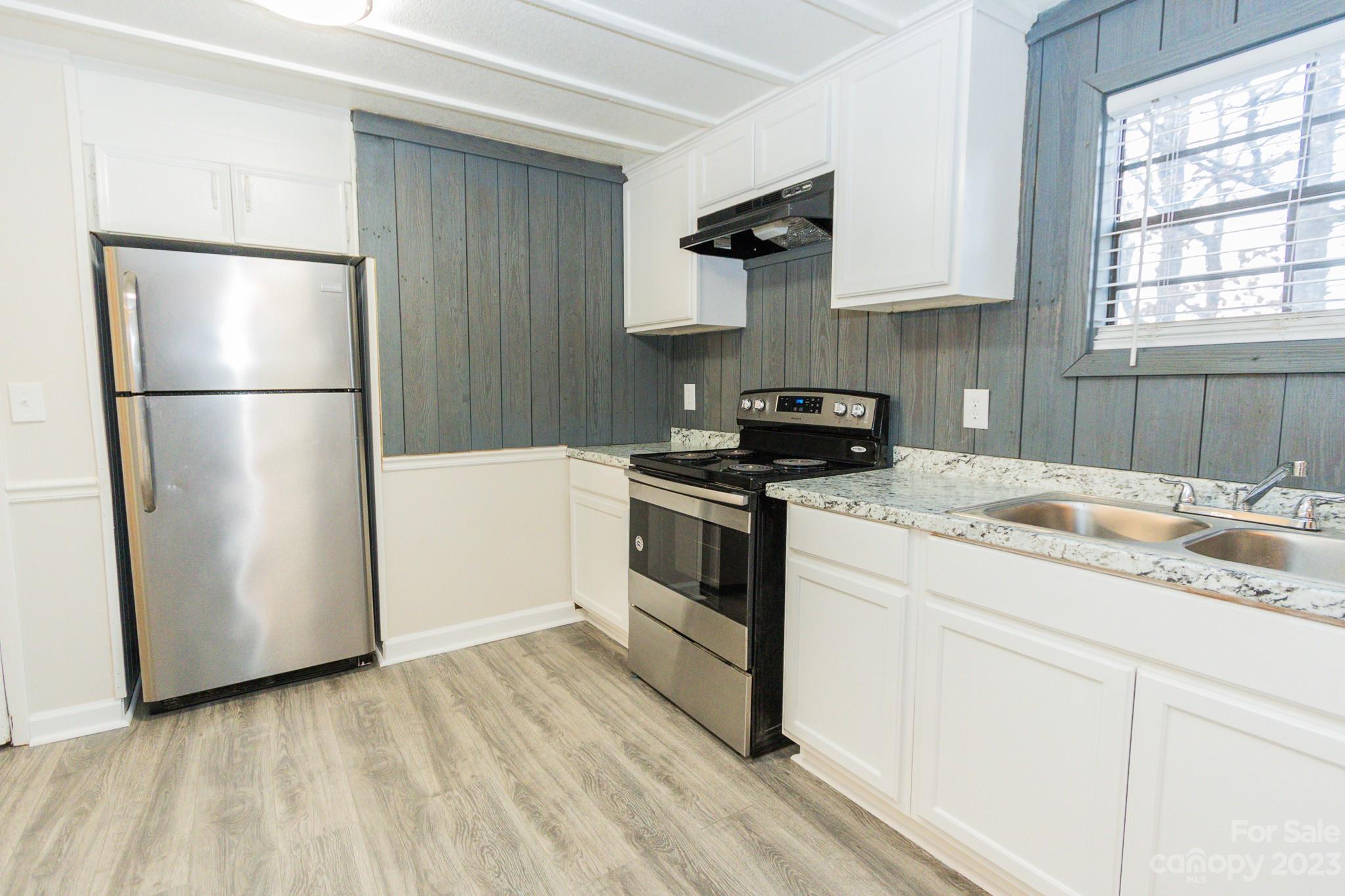 4634 Pleasant Road Heath Springs, SC 29058 - Photo 23 of 43 a kitchen with a sink stainless steel appliances and cabinets