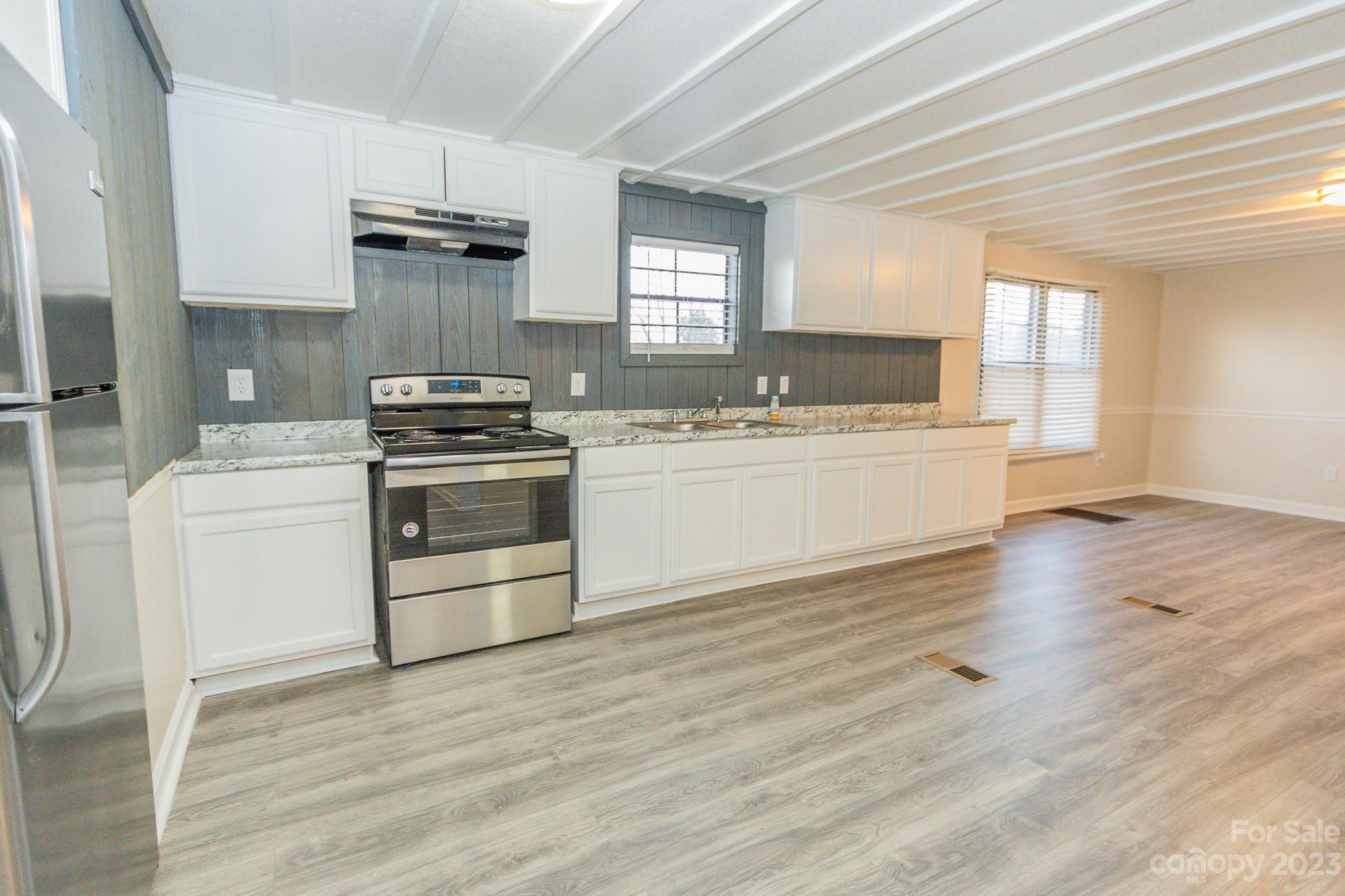 4634 Pleasant Road Heath Springs, SC 29058 - Photo 25 of 43 a kitchen with a stove a sink and a refrigerator