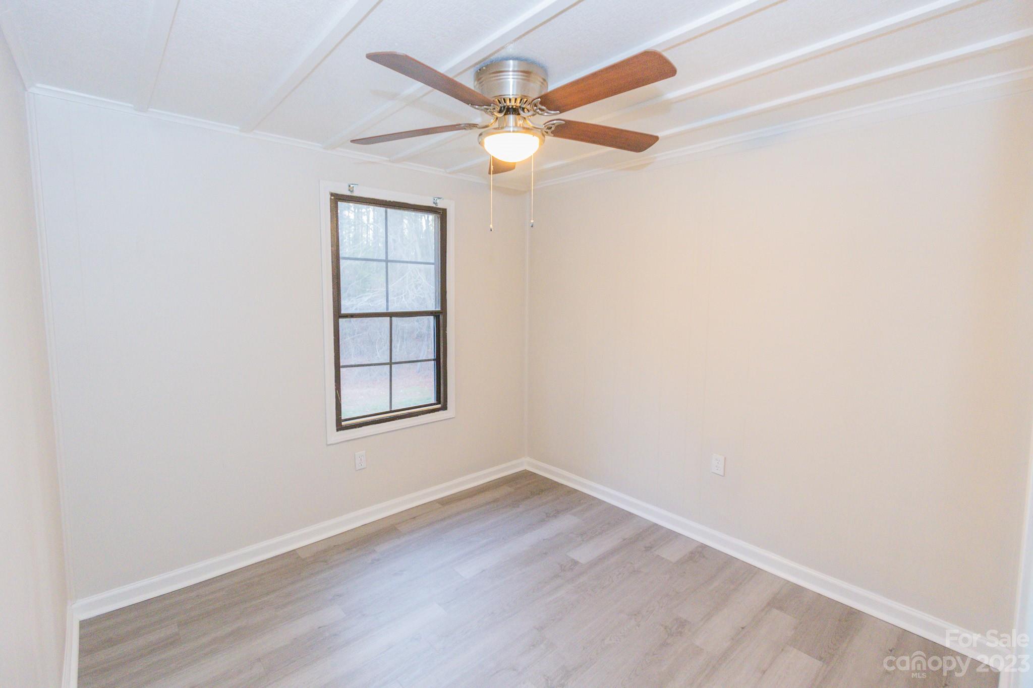 4634 Pleasant Road Heath Springs, SC 29058 - Photo 5 of 43 an empty room with wooden floor and windows
