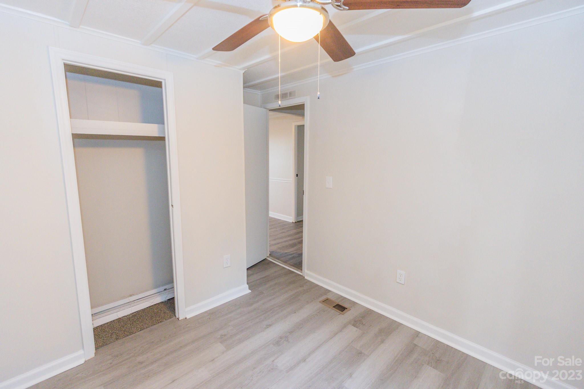 4634 Pleasant Road Heath Springs, SC 29058 - Photo 6 of 43 a view of an empty room with wooden floor